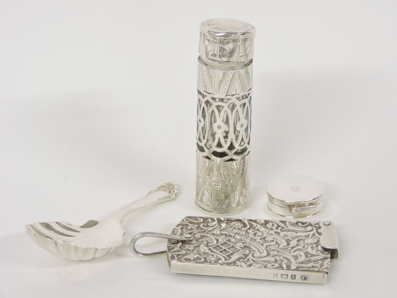 A Mappin & Webb silver caddy spoon, a glass jar in a silver holder, a note book, and a tiny circular