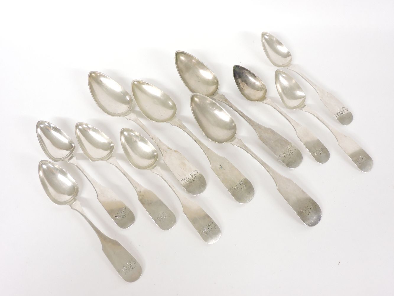 A collection of fiddle pattern dessert and tablespoons, stamped 'T W Clark'