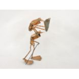 A humorous hand beaten copper sculpture, depicting a frog leapfrogging an elder frog, the elder