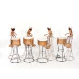 A set of four hand beaten copper frog drummers, each perched upon a high chair, the drums fitted