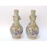 A pair of Canton porcelain bottle vases, restored, 24.5cm high