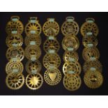 Twenty-four old horse brasses, including pierced suns, hearts, crosses