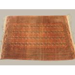 Three Turkoman style red ground rugs, largest 180 x 123cm, and a flat weave rug, damaged