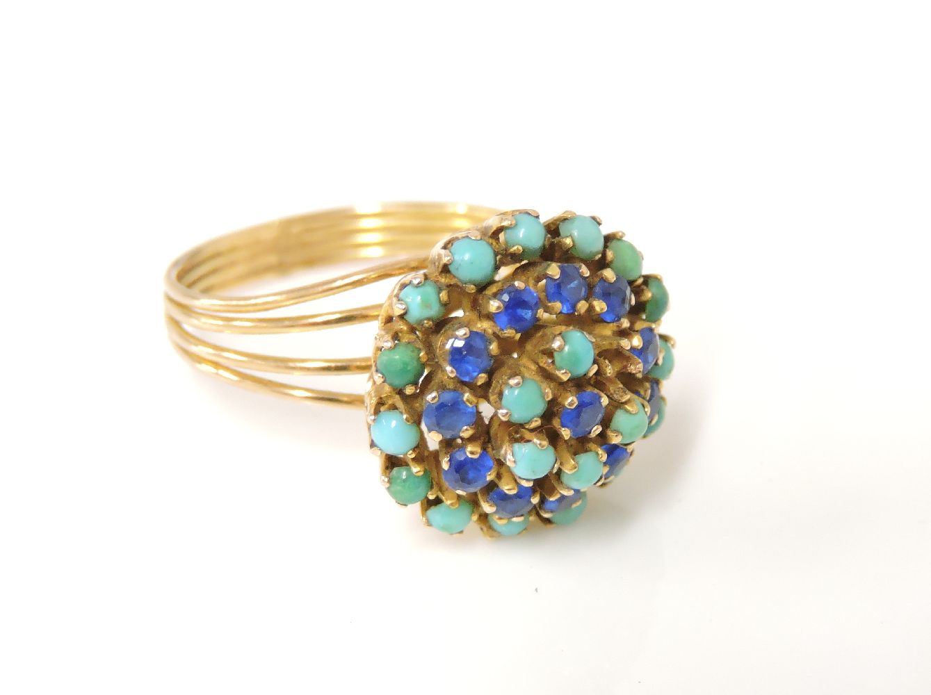 A gold synthetic blue spinel, turquoise and stained howlite cluster ring, tested as approximately