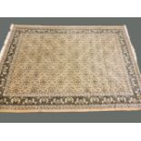 An Oriental fawn ground rug, repeating design, 242 x 325cm