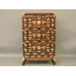 A Chinese elm and brass mounted cupboard, with four short drawers over three pairs of cupboard doors