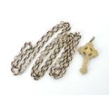 A gold belcher link guard chain, tested as approximately 9ct gold, together with a gold Celtic cross