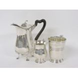 A silver hot water jug, London 1902, a christening mug, by Roberts & Belk, Sheffield 1929, and