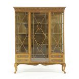 A large Edwardian mahogany triple fronted display cabinet, the central glazed door with strung