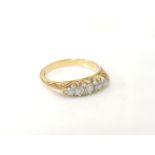 A five stone graduated diamond ring, marked 18ct, 3.9g