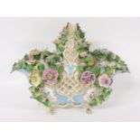 An early 20th century porcelain basket, flower encrusted, with painted bird panels, 22cm high