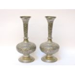 A pair of Indian white metal vases, with tapering slender neck and globular body with circular