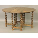 An antique oval oak dining table, with open barley twist carved supports, 130 x 106cm