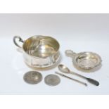 A German silver cup, a silver tea strainer, Irish silver egg spoon, a silver swizzle stick, a silver