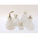 A small collection of cut glass and silver, mounted scent bottles and atomisers