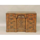 A 19th century American walnut kneehole desk, with banded top over central shell carved drawer, over