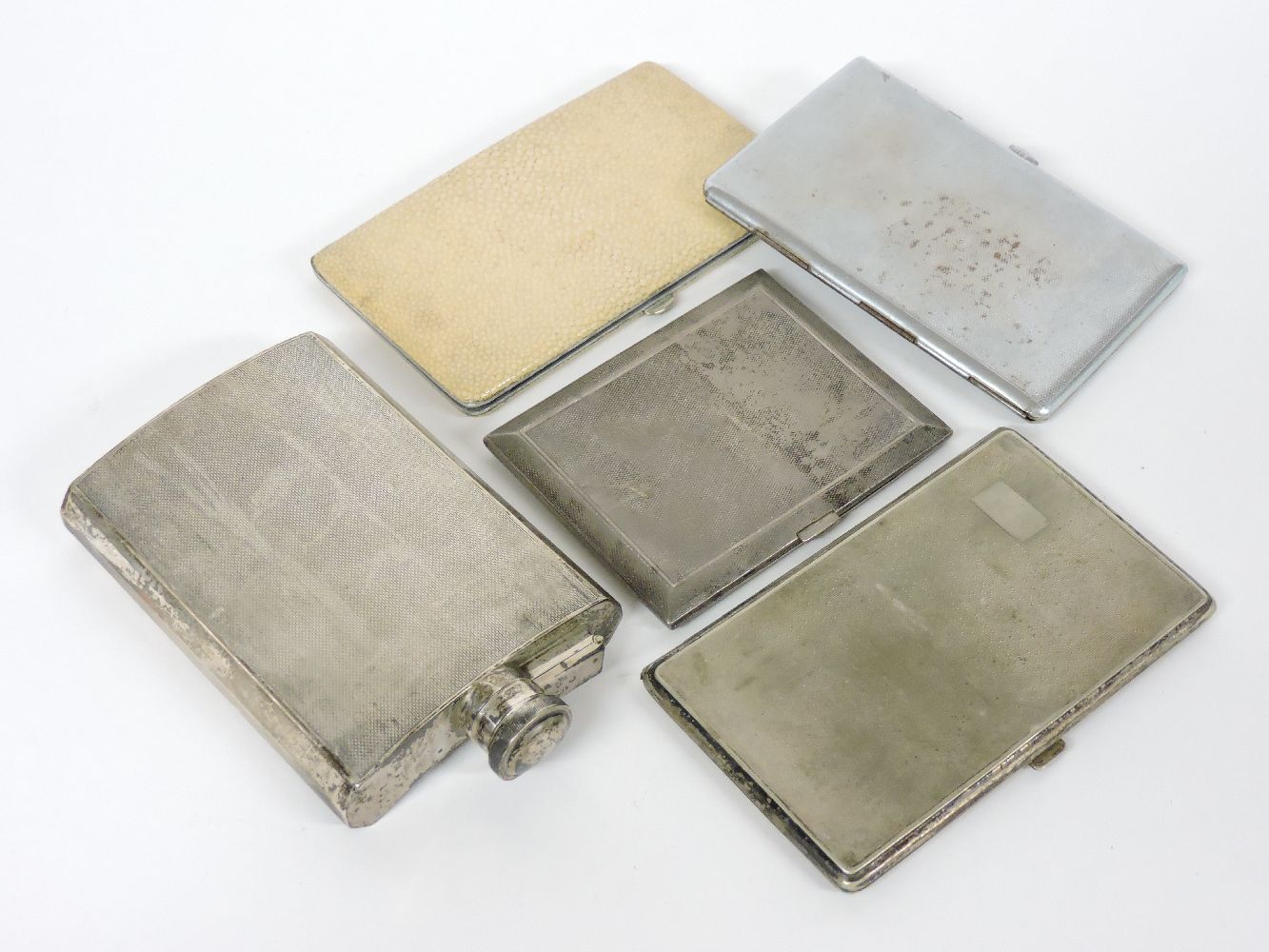 A silver engine turned hip flask, 15cm, two silver cigarette cases, a shagreen mounted case, and a