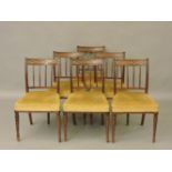 A set of six mahogany dining chairs, with blind fret work, top rails, over stuffed seats