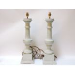 A pair of grey painted turned table lamp bases, 66cm tall