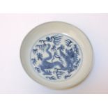 A Chinese blue and white dragon dish, seal mark, 17cm diameter