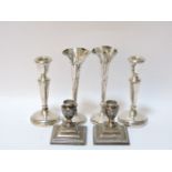 Two pairs of squat filled silver candlesticks, and two silver bud vases