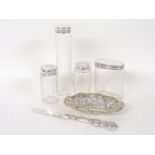 Four silver topped dressing table jars, a pierced silver dish, and a knife