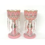 A pair of Victorian pink opaque glass lustres, decorated in enamel with foliate swags
