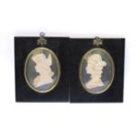 A pair of 20th century wax relief silhouettes, of a maiden and naval officer, by Leslie Ray, in