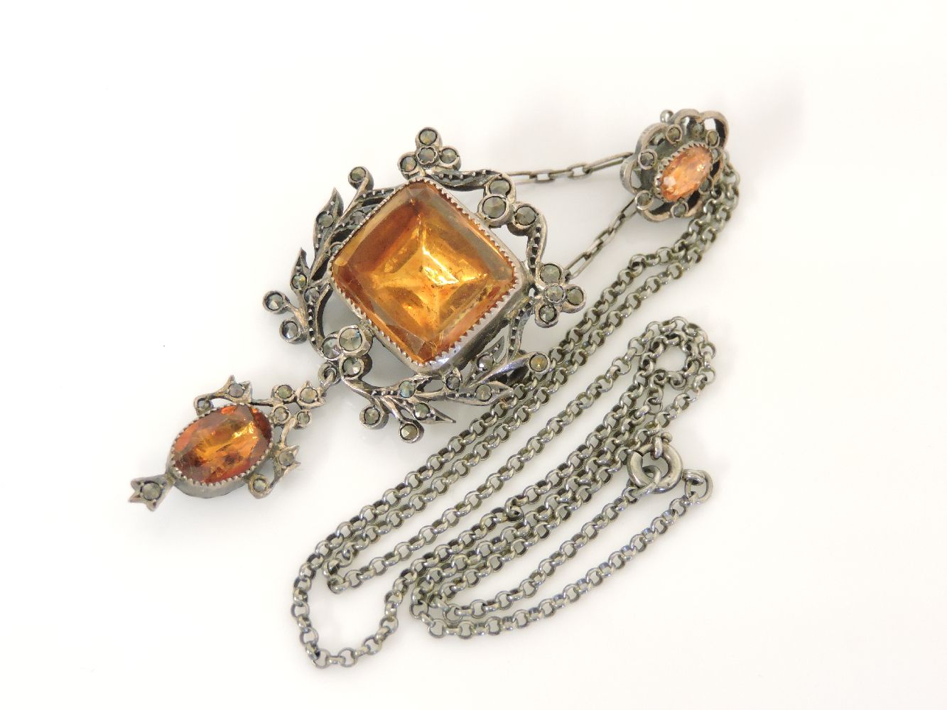 A French silver foiled back quartz and marcasite brooch/pendant, circa 1905, on chain