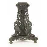 A late 19th century Anglo Indian hardwood jardinière stand, profusely carved with animals and