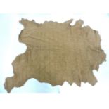 A full cow hide, in medium tan, approximately 260 x 220cm