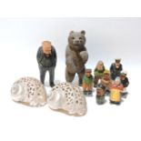 A collection of carvings, Winston Churchill, sailors, a Black Forest bear, and a pair of pierced