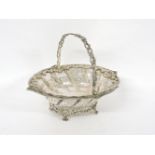 A silver pierced basket, by Charles Stuart Harris, London 1911, 16cm long, 7oz