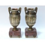 A pair of late 19th century gilt bronze urns, with rouge marble plinths, 24cm high