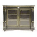 A 19th century ebonised display cabinet, with a pair of glazed doors between two pairs of columns,