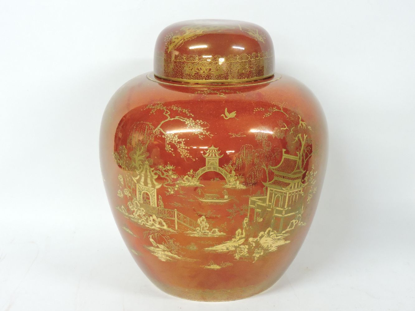 A Carlton Ware rust ground ginger jar and cover, restored cover, 30.5cm