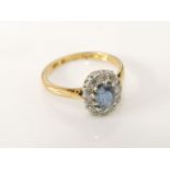 An oval cut sapphire and diamond cluster ring, marked 18ct and plat, 3.21g