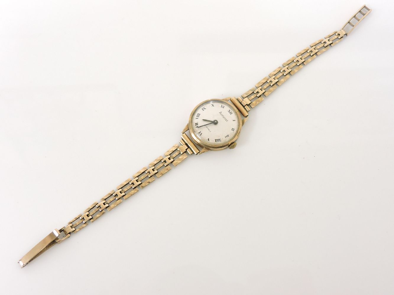 A 9ct gold ladies Accurist mechanical strap watch, with a later 9ct bracelet, silvered dial and