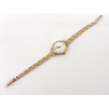A 9ct gold ladies Accurist mechanical strap watch, with a later 9ct bracelet, silvered dial and
