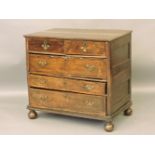 An 18th century walnut chest of two short and three long drawers, standing on bun feet, 95cm wide