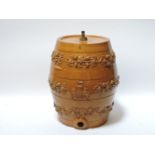 A salt glazed spirit barrel, with vine decoration and coat of arms