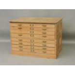 A 20th century panelled pine plan chest of eight drawers, 126cm wide, 91cm deep, 90cm tall