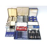 A quantity of cased sets of silver teaspoons, napkin rings, silver handled knives, etc