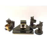 Three carved Black Forest bear match and spill stands, and a glass inkstand