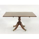 A mahogany tilt top rectangular breakfast table, with reeded edge on outswept legs, with brass