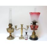Two Victorian oil lamps, and a three branch candelabra
