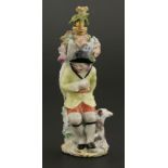 A Chelsea gold-mounted porcelain scent bottle,modelled as a flower seller, sitting on a stump
