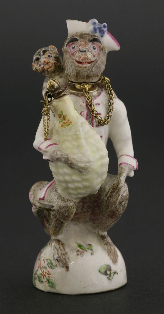 A Chelsea gold-mounted porcelain double scent bottle,modelled as a crouching monkey in a tricorn hat