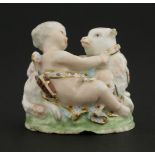 A Chelsea porcelain bonbonnièreincomplete, modelled as a cupid lying by a lamb, its collar inscribed