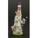 A Chelsea porcelain scent bottle,modelled as a boy and his dog chasing a squirrel around a tree